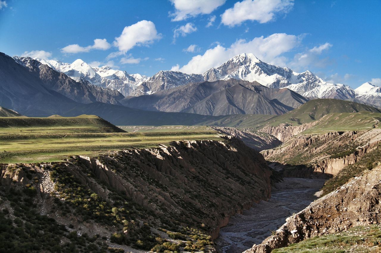 mountain, mountain range, tranquil scene, tranquility, landscape, sky, scenics, beauty in nature, nature, non-urban scene, cloud, cloud - sky, physical geography, day, geology, remote, idyllic, blue, grass, rock - object