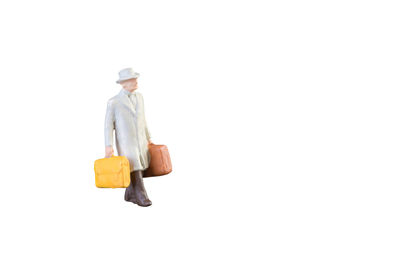 Man wearing hat standing against white background