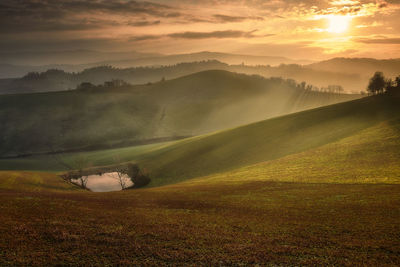 Scenic view of landscape against sky during sunset