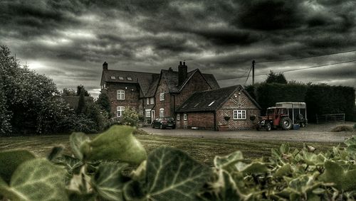 Houses against cloudy sky