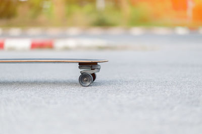 Close-up of skateboard on road