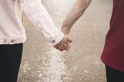 Midsection of couple standing in sunlight