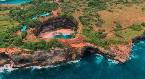 High angle view of rock formations by sea