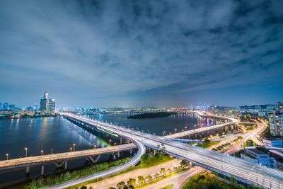 High angle view of city lit up at night