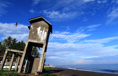 Low angle view of built structure on beach against sky