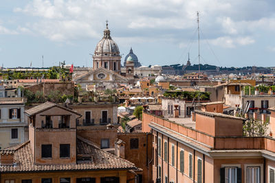 Church amidst cityscape against sky at piazza di spagna