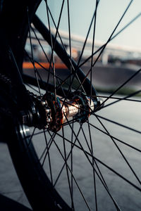 Close-up of bicycle wheel against sky