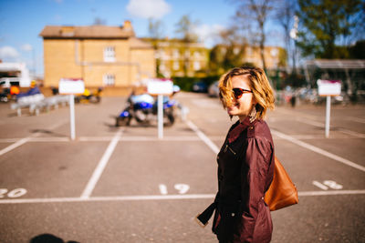 Woman standing on city street