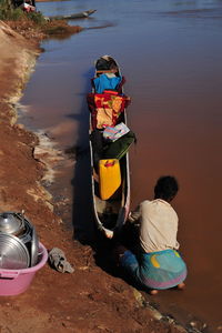 Rear view of people sitting at beach