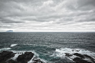 Scenic view of sea against cloudy sky