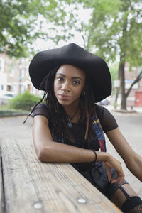 Portrait of beautiful young woman sitting outdoors