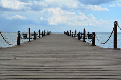 Pier over sea against sky