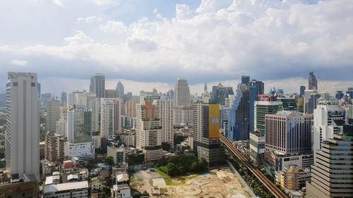 High angle view of modern buildings in city against sky