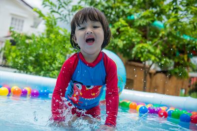 Cute boy playing in swimming pool