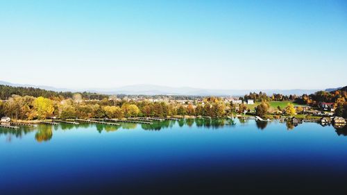 Scenic view of lake against clear blue sky