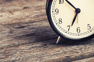 High angle view of alarm clock on wooden table