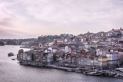 High angle view of townscape by river against sky