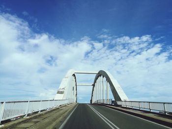 View of suspension bridge against cloudy sky