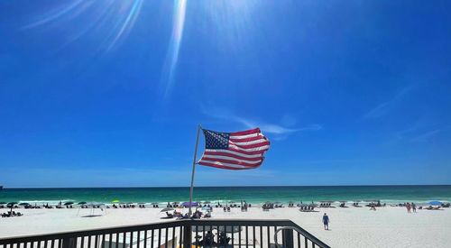 Scenic view of beach against blue sky