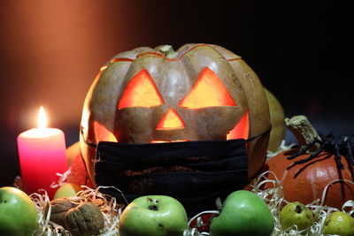 Close-up of illuminated tea light candles against black background