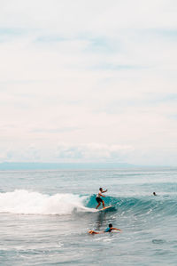 Man surfing on sea against sky