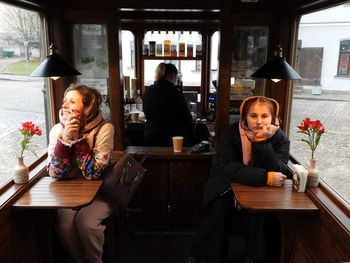 Portrait of young woman sitting in bus