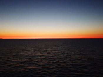 Scenic view of sea against clear sky during sunset
