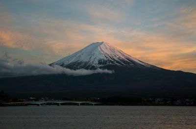 Scenic view of snowcapped mountains against sky during sunset