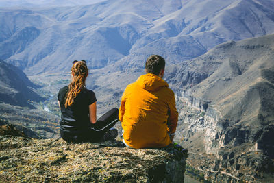 Rear view of people looking at mountain