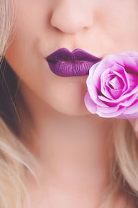 Cropped image of woman with purple rose