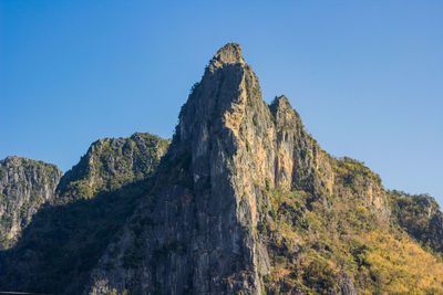 Low angle view of rock formation against clear sky