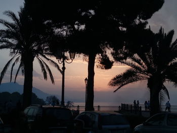 Silhouette palm trees against sky during sunset