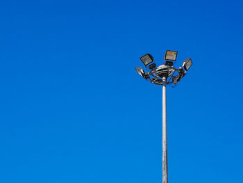 Low angle view of street light against clear blue sky