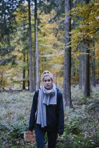 Portrait of woman standing in forest