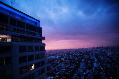 High angle view of illuminated buildings against sky at sunset