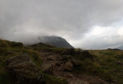 Scenic view of mountains against cloudy sky