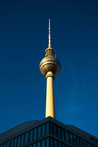 Low angle view of communications tower against sky