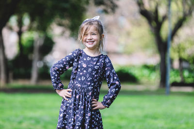 Portrait of cheerful girl standing in garden