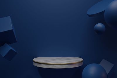 High angle view of illuminated electric lamp on table against blue wall