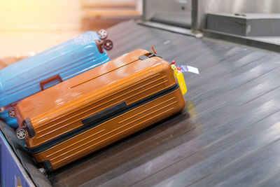 High angle view of luggage on conveyor belt at airport