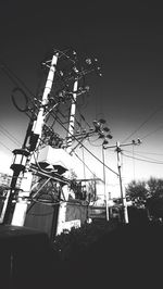 Low angle view of power lines against sky