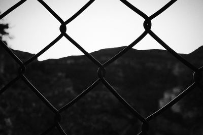 Close-up of chainlink fence against clear sky