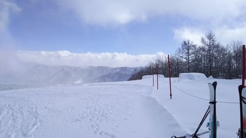 Snow covered field against sky