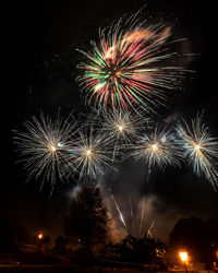 Low angle view of firework display at night