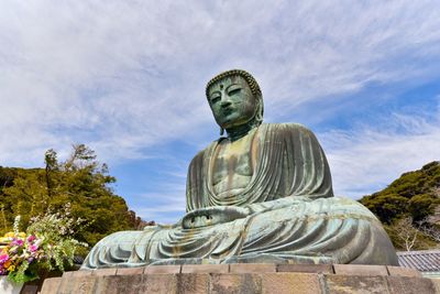 Low angle view of statue against sky