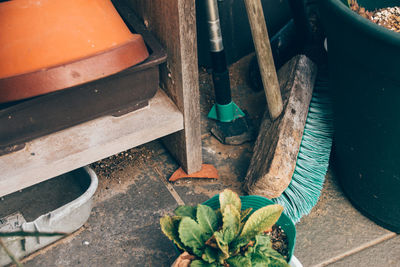 High angle view of broom and potted plant by old cabinet