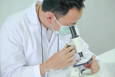 Scientist working at table in laboratory