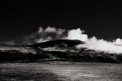 Scenic view of landscape against cloudy sky