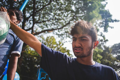 Close-up side view of young man playing soccer