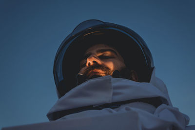 Astronaut standing against clear sky